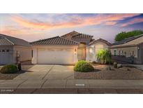 Charming single-story home with desert landscaping and a beautiful sunset backdrop at 3338 E Lavey Ln, Phoenix, AZ 85032