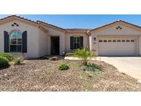 Charming single-story home with desert landscaping and a two-car garage on a sunny day at 4229 E Nightingale Ln, Gilbert, AZ 85298