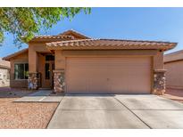 Charming single-story home with a two-car garage, low maintenance landscaping, and a cozy front porch at 4817 W St Charles Ave, Laveen, AZ 85339