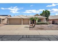 Charming single-story home with a three-car garage and well-maintained desert landscaping at 6368 W Firebird Dr, Glendale, AZ 85308