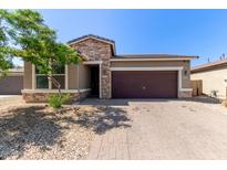 Charming single-story home with a two-car garage, stone accents, and low-maintenance landscaping at 7620 W Pioneer St, Phoenix, AZ 85043