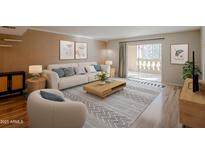Bright living room featuring a modern design, neutral tones, stylish decor, and access to the balcony at 7970 E Camelback Rd # 101, Scottsdale, AZ 85251