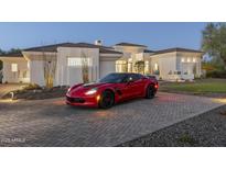 Elegant home exterior showcasing a red sports car parked on the brick driveway and desert landscaping at 9441 N 129Th Pl, Scottsdale, AZ 85259