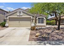 Charming single-story home with a two-car garage and desert landscaping at 11330 W Eden Mckenzie Dr, Surprise, AZ 85378