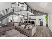 Open floor plan with a spacious living room that includes a modern kitchen and staircase to the second story at 1174 E Belmont Ave, Phoenix, AZ 85020