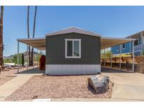 Charming home featuring an extended carport, desert landscaping, and a quaint single window at 12811 N 19Th Pl, Phoenix, AZ 85022