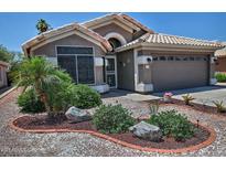 Charming single-story home with well-maintained landscaping, desert accents, and a two-car garage at 1741 S Clearview Ave # 13, Mesa, AZ 85209