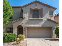 Charming two-story home featuring a stucco exterior, well-manicured landscaping, and an attached two-car garage at 2018 W Marconi Ave, Phoenix, AZ 85023