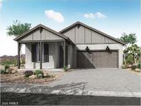 Charming single-story home featuring a neutral color scheme, a two-car garage and desert landscaping at 21297 W Edgemont Ave, Buckeye, AZ 85396