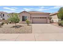 Inviting single-story home with a tile roof, two car garage and low-maintenance desert landscaping at 3026 W Silver Fox Way, Phoenix, AZ 85045