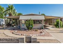 Charming single-story home featuring desert landscaping and covered parking at 3239 E Kings Ave, Phoenix, AZ 85032
