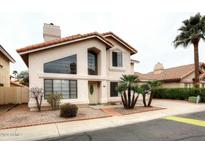 Charming two-story home featuring stucco siding, tile roof, desert landscaping, and a welcoming entrance at 4437 E Villa Theresa Dr, Phoenix, AZ 85032