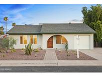 Charming single-story home featuring desert landscaping and a welcoming arched doorway at 4611 E Fremont St, Phoenix, AZ 85042