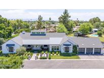 Beautifully landscaped modern farmhouse with gray metal roof and pristine white exterior at 4708 N 41St Pl, Phoenix, AZ 85018