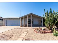 Charming single-story home featuring desert landscaping, a covered entryway, and an attached two-car garage at 4740 W Bloomfield Rd, Glendale, AZ 85304