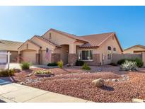 Well-maintained home boasting desert landscaping, a three-car garage, and inviting curb appeal in a lovely neighborhood at 5524 E Garnet Cir, Mesa, AZ 85206