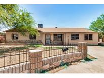 Charming single-story home featuring a stone facade, desert landscaping, and a decorative front fence at 6426 W Mulberry Dr, Phoenix, AZ 85033