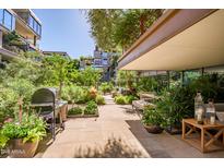 Expansive patio showcases lush landscaping, grill area, comfortable seating for outdoor relaxation and entertaining at 7167 E Rancho Vista Dr # 3002, Scottsdale, AZ 85251