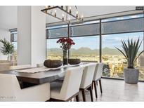 Bright dining room features a modern chandelier, large windows, and panoramic city and mountain views at 7180 E Kierland Blvd # 916, Scottsdale, AZ 85254