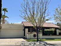 Charming single story home with a terracotta roof and manicured front yard landscaping at 8947 N 84Th Way, Scottsdale, AZ 85258