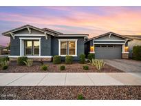 Charming home with a well-maintained front yard featuring desert landscaping and a two-car garage at 10322 E Topaz Ave, Mesa, AZ 85212