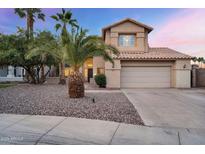 Two-story home with desert landscaping, tile roof, and attached two car garage at 1574 E Scott Ave, Gilbert, AZ 85234