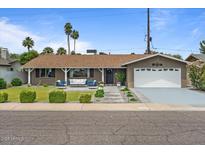 Charming single-story home with a well-manicured front yard and inviting outdoor seating area at 5332 N 81St Pl, Scottsdale, AZ 85250