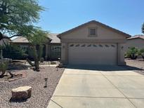 Charming single-story home with desert landscaping and a spacious driveway on a sunny day at 6418 S Pinaleno Pl, Chandler, AZ 85249