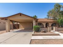 Charming home with a covered carport, landscaped front yard, and a welcoming entrance at 7340 W Meadowbrook Ave, Phoenix, AZ 85033