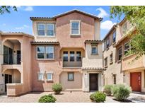 Charming two-story townhome featuring a covered front porch and well-maintained xeriscaped front yard at 7718 W Pipestone Pl, Phoenix, AZ 85035