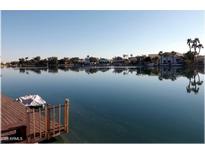 Beautiful lake view featuring a private dock and serene waterfront homes at 8759 W Port Au Prince Ln, Peoria, AZ 85381