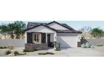 Charming single-story home boasts stone accents, a two-car garage, and an inviting, landscaped front yard at 8921 E Covina St, Mesa, AZ 85207