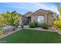 Charming single-story home with manicured landscaping and green lawn at 10961 W Chase Ln, Avondale, AZ 85323