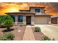 Charming two-story home with a well-manicured front yard and an attached two-car garage at 11936 W Alvarado Rd, Avondale, AZ 85392