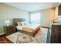 Bright bedroom with a large bed, decorative rug, and wood-style furniture at 1645 W Baseline Rd # 2026, Mesa, AZ 85202