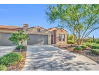 Beautiful single-story home featuring a three car garage, brick accents, and manicured landscaping at 16961 W Holly St, Goodyear, AZ 85395