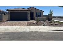 Charming single-story home features a tile roof, neutral stucco, blue shutters, and a 2-car garage at 18153 W Hiddenview Dr, Goodyear, AZ 85338