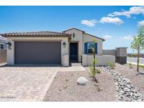 Charming single-story home with a well-maintained front yard, desert landscaping, and a two-car garage at 18153 W Hiddenview Dr, Goodyear, AZ 85338