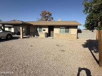Charming single-story home featuring a covered porch and low-maintenance landscaping at 1841 N Wilbur Cir, Mesa, AZ 85201