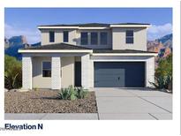 Two-story home with a two car garage, desert landscaping, a covered entry, and a neutral color scheme at 27279 N 73Rd Ln, Peoria, AZ 85383