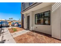 Townhome exterior with tidy landscaping, marked parking, and private entrance at 4220 N 32Nd St # 14, Phoenix, AZ 85018