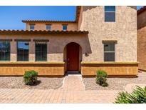 Charming two-story home features a red front door, stucco facade, and well-manicured landscaping at 4745 W Fremont Rd, Laveen, AZ 85339
