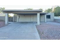 Exterior home elevation featuring a carport, xeriscaping, and neutral color palette at 4902 S Fair Ln, Tempe, AZ 85282