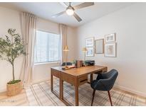 Bright home office with a wooden desk, stylish decor, neutral rug, and window providing natural light at 654 N Vine St, Chandler, AZ 85225
