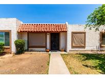 Charming home exterior with decorative tile roof, cozy front patio and easy access to the front door at 6606 N 46Th Ave, Glendale, AZ 85301