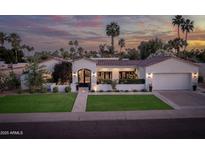 Elegant single-story home boasting mature landscaping and a tile roof, under a colorful sunset sky at 8045 E Del Caverna Dr, Scottsdale, AZ 85258