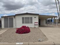 Charming single-story home with a covered parking and well-maintained desert landscaping at 918 S Evangeline Ave, Mesa, AZ 85208
