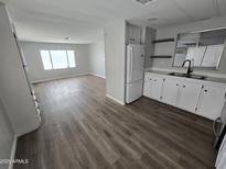 Bright living room showcasing new laminate flooring and large windows for ample natural light at 918 S Evangeline Ave, Mesa, AZ 85208