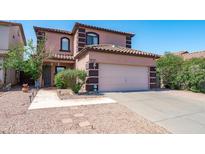 Inviting two-story home featuring a desert landscape and a two car garage at 1017 W Lydia Ln, Phoenix, AZ 85041