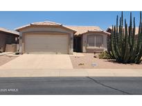 Charming single-story home with stucco siding, desert landscaping, and a two-car garage at 1450 E Doral Dr, Chandler, AZ 85249